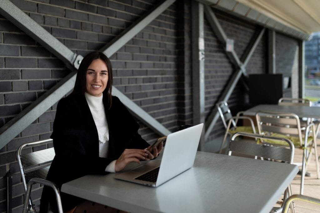 successful woman realtor working on laptop online sitting at table